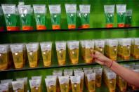 A woman checks a skin care product inside a Patanjali store in Ahmedabad