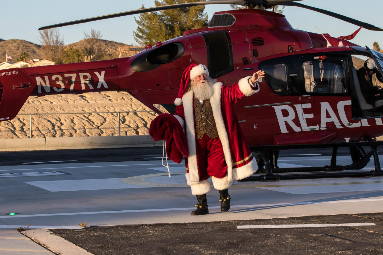 Santa Claus arrives at Providence St. Mary Medical Center in Apple Valley via a REACH Medical Services helicopter.