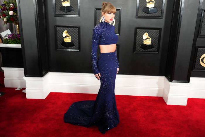 Taylor wears a shimmering long sleeve crop top and form fitting column skirt