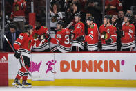 FILE - In this March 11, 2020, file photo, Chicago Blackhawks' Patrick Kane (88) celebrates with teammates on the bench after scoring a goal during the third period of an NHL hockey game against the San Jose Sharks in Chicago. While the coronavirus pandemic circles the world, sports business executives are having conversations about lucrative advertising and marketing contracts with no games on the horizon. (AP Photo/Paul Beaty, File)