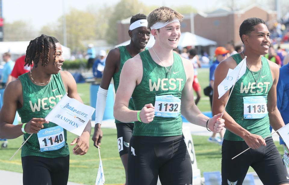 Aidan Jacobsen, center, celebrates with teammates Todd Rent, Izaiah Loveless and Moustafa Tiea after clinching first place in the distance medley at the 2023 Drake Relays on Friday, April 28, 2023. Jacobsen is pictured wearing a necklace with his late grandfather Dean Jacobsen's wedding ring attached to it.