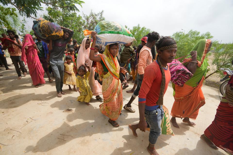 People evacuated from a village near Jakhau ahead of cyclone Biparjoy arrive at a shelter at Naliya in Kutch district of the Western Indian state of Gujarat (AP)