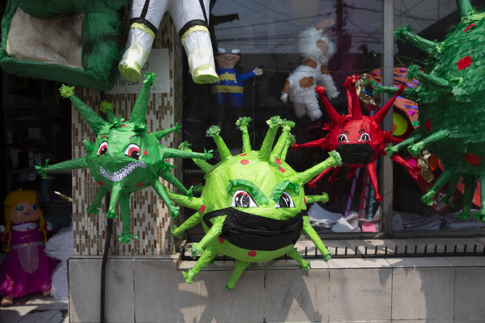 Piñatas depicting the new coronavirus are displayed in a store at Colon park in Guatemala City, Tuesday, April 14, 2020. (AP Photo/Moises Castillo)