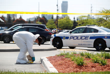 A police forensics investigator collects evidence at Bombay Bhel restaurant, where two unidentified men set off a bomb late Thursday night, wounding fifteen people, in Mississauga, Ontario, Canada May 25, 2018. REUTERS/Mark Blinch