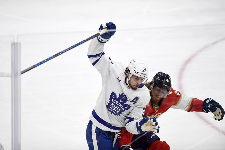 Toronto Maple Leafs center Auston Matthews and Florida Panthers defenseman Marc Staal battle for the puck during the first period of an NHL hockey game, Thursday, March 23, 2023, in Sunrise, Fla. (AP Photo/Michael Laughlin)