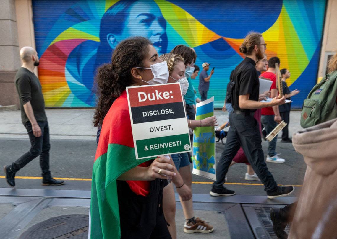 Demonstrators march along N. Main Street calling on Duke University to divest and reinvest during a May Day March on Wednesday, May 1, 20214 in Durham, N.C.