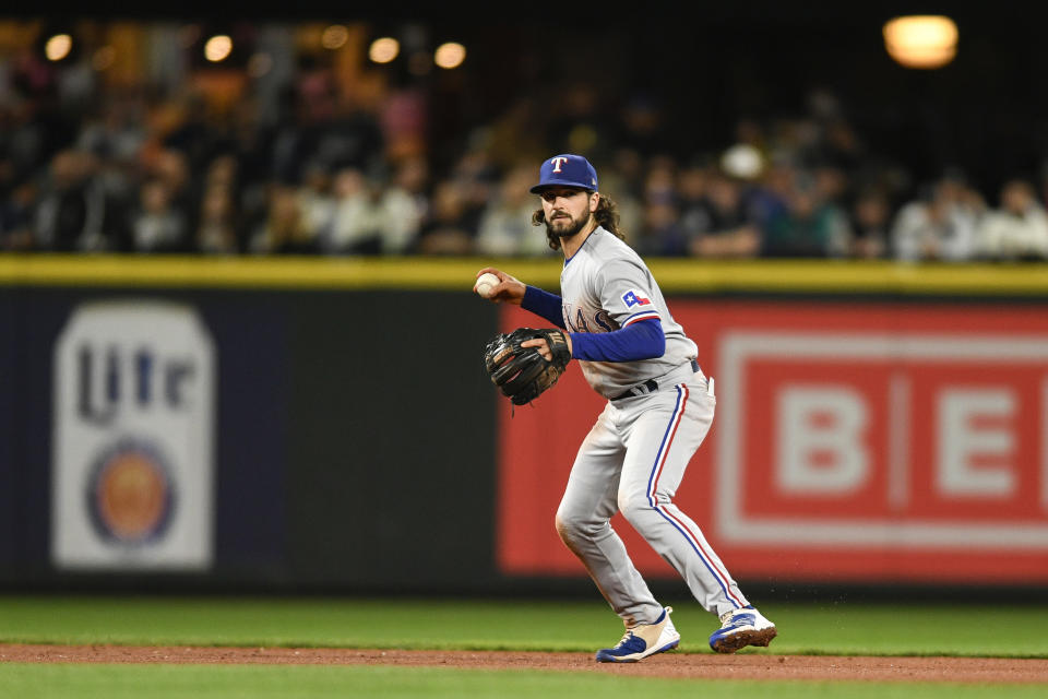 Texas Rangers third baseman Josh Smith prepares to throw to first baseman Nathaniel Lowe for the out on Seattle Mariners' Sam Haggerty during the sixth inning of a baseball game Wednesday, Sept. 28, 2022, in Seattle. (AP Photo/Caean Couto)