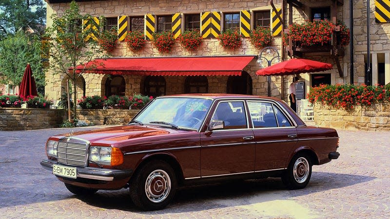 A photo of a red Mercedes W123 sedan. 