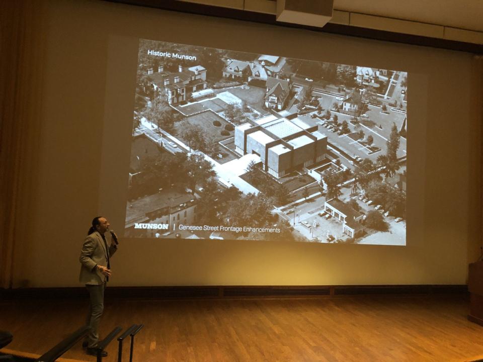 Landscape architect Zakary Steele, of Steele Landscape Architecture, of Fairport, stands in front of a photo showing the grounds of Munson on Genesee Street in Utica while he explains a project to redo the site's landscaping in the Munson auditorium on April 11, 2024. Steele and his firm have designed a landscaping project for the site to make it more welcoming, more useful for outdoor programming and more in keeping with the history of its two landmark buildings.
