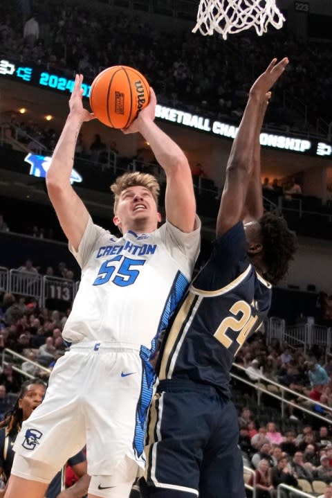 Creighton’s Baylor Scheierman (55) puts up a shot with Akron’s Ali Ali defending during the first half of a first-round college basketball game in the NCAA Tournament, in Pittsburgh, Thursday, March 21, 2024. Creighton won 77-60. (AP Photo/Gene J. Puskar)