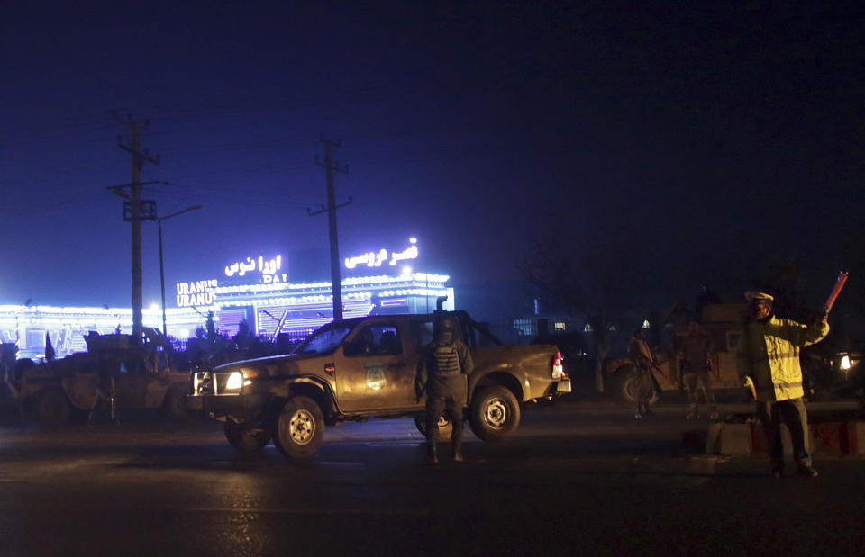 Security forces inspect the site of a suicide attack, inside a wedding hall in Kabul, Afghanistan, Nov. 20, 2018. Afghan officials said the suicide bomber targeted a gathering of Muslim religious scholars in Kabul, killing tens of people. A Public Health Ministry spokesman said another 60 people were wounded in the attack, which took place as Muslims around the world marked the birthday of the Prophet Mohammad. (AP Photo/Massoud Hossaini)
