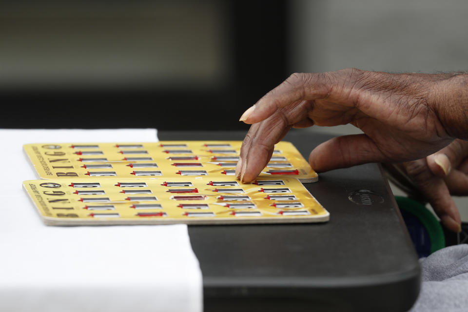 A resident at the Southern Pines nursing home takes part in the daily bingo game in Warner Robins, Ga., on Thursday, June 25, 2020. (AP Photo/John Bazemore)