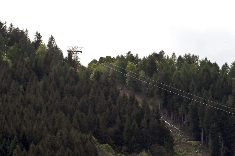 A view of the cable car line that collapsed near Stresa, Italy, Sunday, May 23, 2021. A cable car taking visitors to a mountaintop view of some of northern Italy's most picturesque lakes plummeted to the ground Sunday and then tumbled down the slope, killing at least 13 people and sending two children to the hospital, authorities said. (AP Photo/Antonio Calanni)