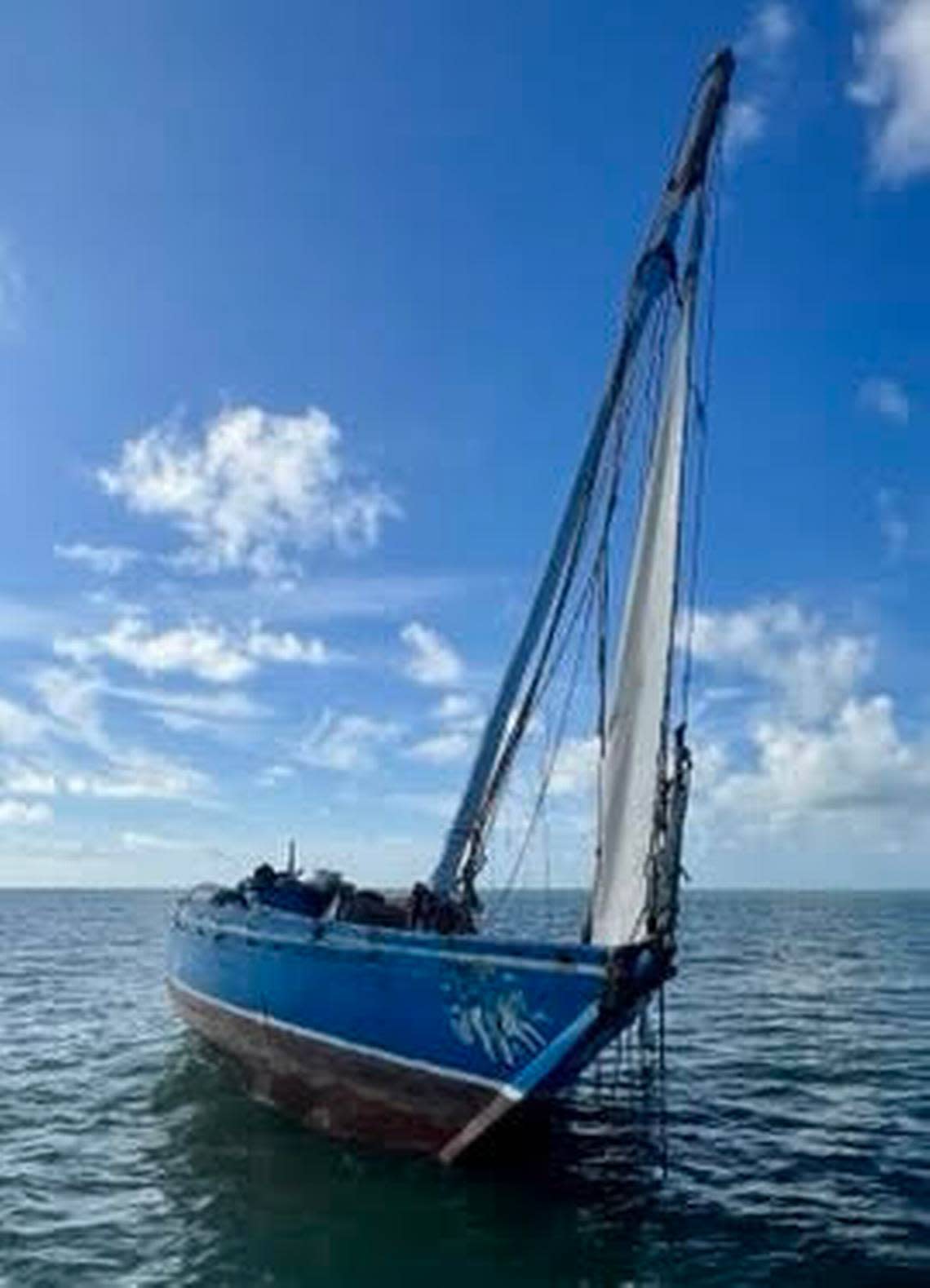 A Haitian migrant sailboat is beached on a sandbar off Windley Key on Tuesday, Nov. 22, 2022. Roughly 200 people reached the Keys on the boat the day before. A man’s body was found in the same area three days later. Authorities are investigating if he was among the group of migrants.
