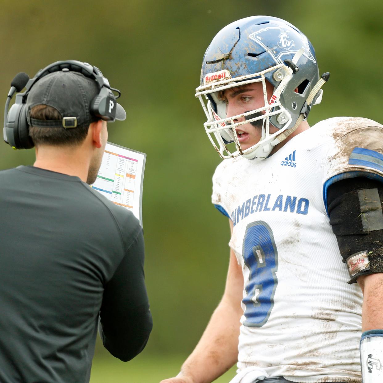 Andrew Ray confers with his coach during a Sept. 30 game. On Friday night, he led the Cumberland Clippers to a 21-8 win over St. Raphael.