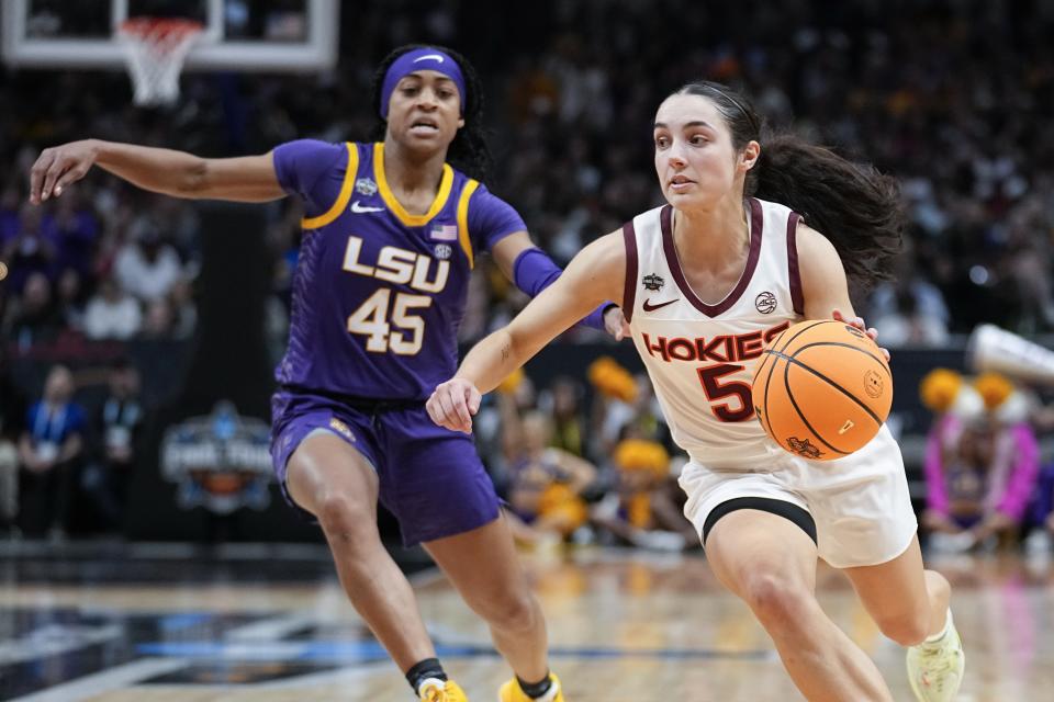 Virginia Tech's Georgia Amoore drives past LSU's Alexis Morris during the second half of an NCAA Women's Final Four semifinals basketball game Friday, March 31, 2023, in Dallas. (AP Photo/Tony Gutierrez)