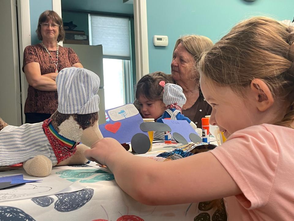 Eliza Waters feeding Dog a fruit snack at the G Lynn Campbell Library on May 22, 2023.