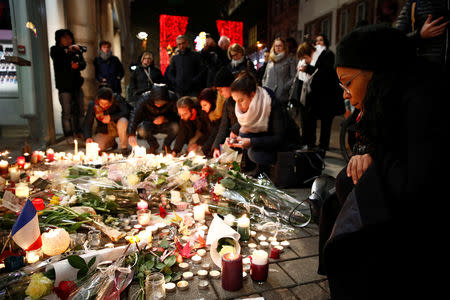 People cry as they light candles in tribute to the victims of the deadly shooting in Strasbourg, France, December 13, 2018. REUTERS/Christian Hartmann