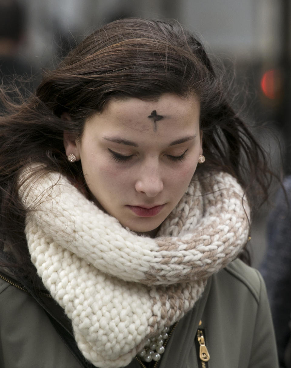 A woman leaves an Ash Wednesday service at St. Patrick's Cathedral, Wednesday, March 5, 2014 in New York. Some Protestant, and all Catholic churches, distribute ashes on the forehead as a sign of repentance and renewal on Ash Wednesday as the 40-day season leading to Easter begins. (AP Photo/Mark Lennihan)