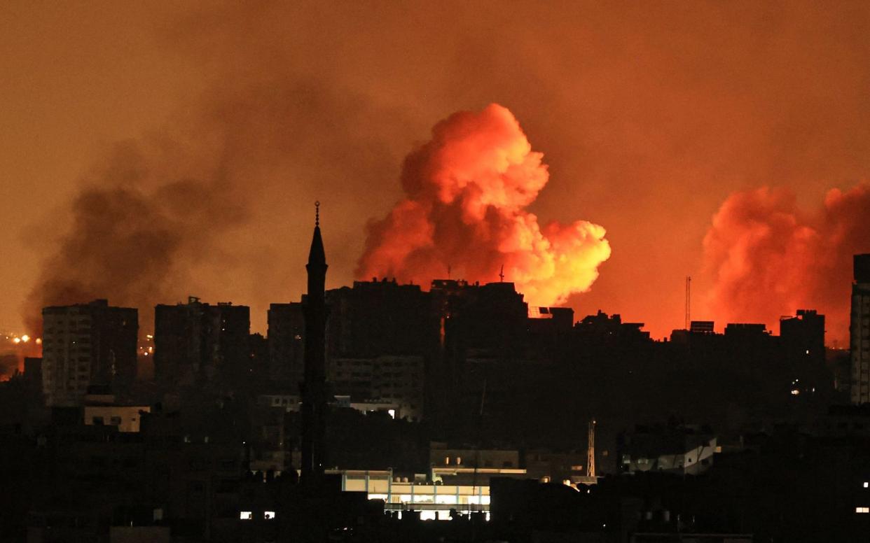 A ball of fire erupts in Gaza City after an Israeli air strike