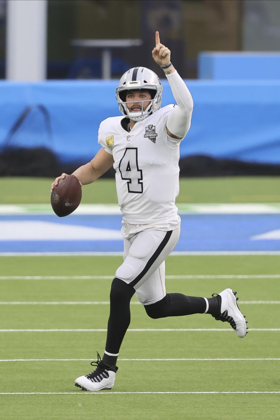 Raiders quarterback Derek Carr scrambles.