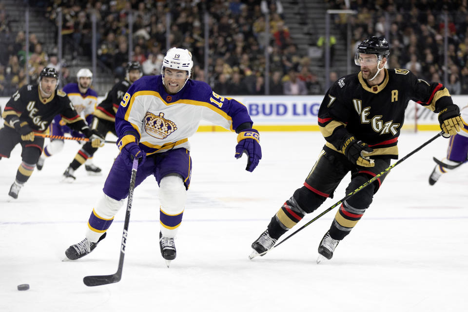 Los Angeles Kings left wing Alex Iafallo (19) skates for the puck against Vegas Golden Knights defenseman Alex Pietrangelo (7) during the first period of an NHL hockey game Saturday, Jan. 7, 2023, in Las Vegas. (AP Photo/Ellen Schmidt)