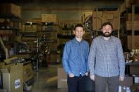 Co-founders Reza Farsi and Mehdi Farsi stand for a portrait in their warehouse at State Bicycle in Tempe