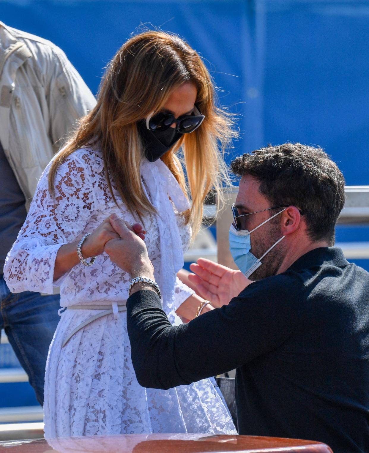 Ben Affleck helps US actress and singer Jennifer Lopez as they board a vaporetto taxi boat on September 9, 2021 after they arrived to attend the 78th Venice Film Festival in Venice. (Getty Images) 