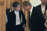 Kansas Gov. Laura Kelly, left, confers with Kansas state Sen. Rick Billinger, right, R-Goodland, before her meeting with top legislators to approve a $829 million package of incentives for a new Panasonic Corp. plant in Kansas, Wednesday, July 13, 2022, at the Statehouse in Topeka, Kan. Billinger is chairman of the Senate's budget committee. (AP Photo/John Hanna)