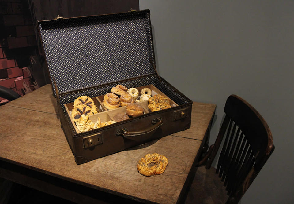 <p>Filled with plastic pastries, this suitcase gets mixed up with Newt’s magical valise. (Photo: Angela Kim/Yahoo) </p>