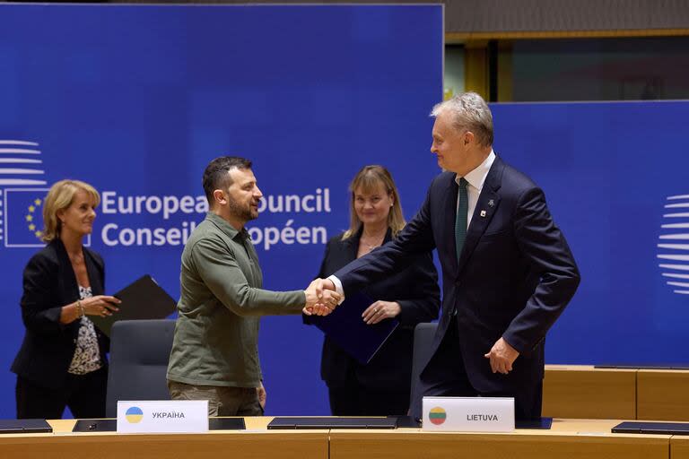 Esta fotografía tomada y difundida por el Servicio de Prensa Presidencial de Ucrania el 27 de junio de 2024 muestra al presidente ucraniano Volodymyr Zelensky (2º izqda.) y al presidente de la República de Lituania Gitanas Nauseda (dcha.) estrechándose la mano durante la ceremonia de firma del Acuerdo de Cooperación en materia de Seguridad entre Ucrania y la República de Lituania durante la Cumbre del Consejo Europeo en la sede de la UE en Bruselas.