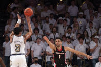 Georgia Tech guard Dallan Coleman shoots a 3-pointer over Georgia guard Jabri Abdur-Rahim during the first half of an NCAA college basketball game Tuesday, Dec. 6, 2022, in Atlanta. (AP Photo/Hakim Wright Sr.)