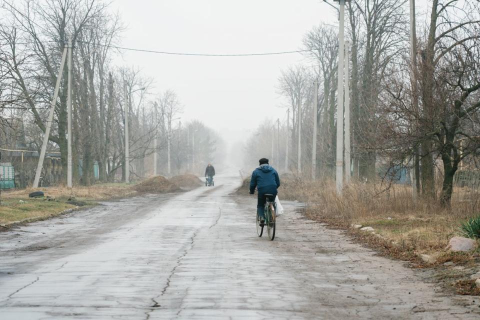 Civilian riding a bike in Krasnohorivka, Donetsk Oblast, Ukraine on February 2, 2024. (Olena Zashko/The Kyiv Independent)