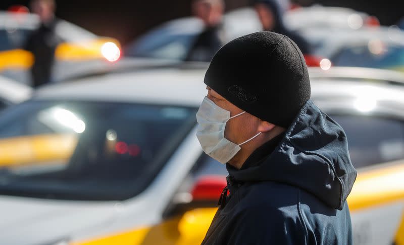 Drivers wait for specialists to have their cars sanitized in Moscow