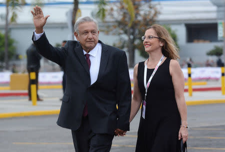 Leftist front-runner Andres Manuel Lopez Obrador of the National Regeneration Movement (MORENA), waves while arriving with his wife Beatriz Gutierrez Muller for the second presidential debate in Tijuana, Mexico May 20, 2018. REUTERS/Ramon Blanco