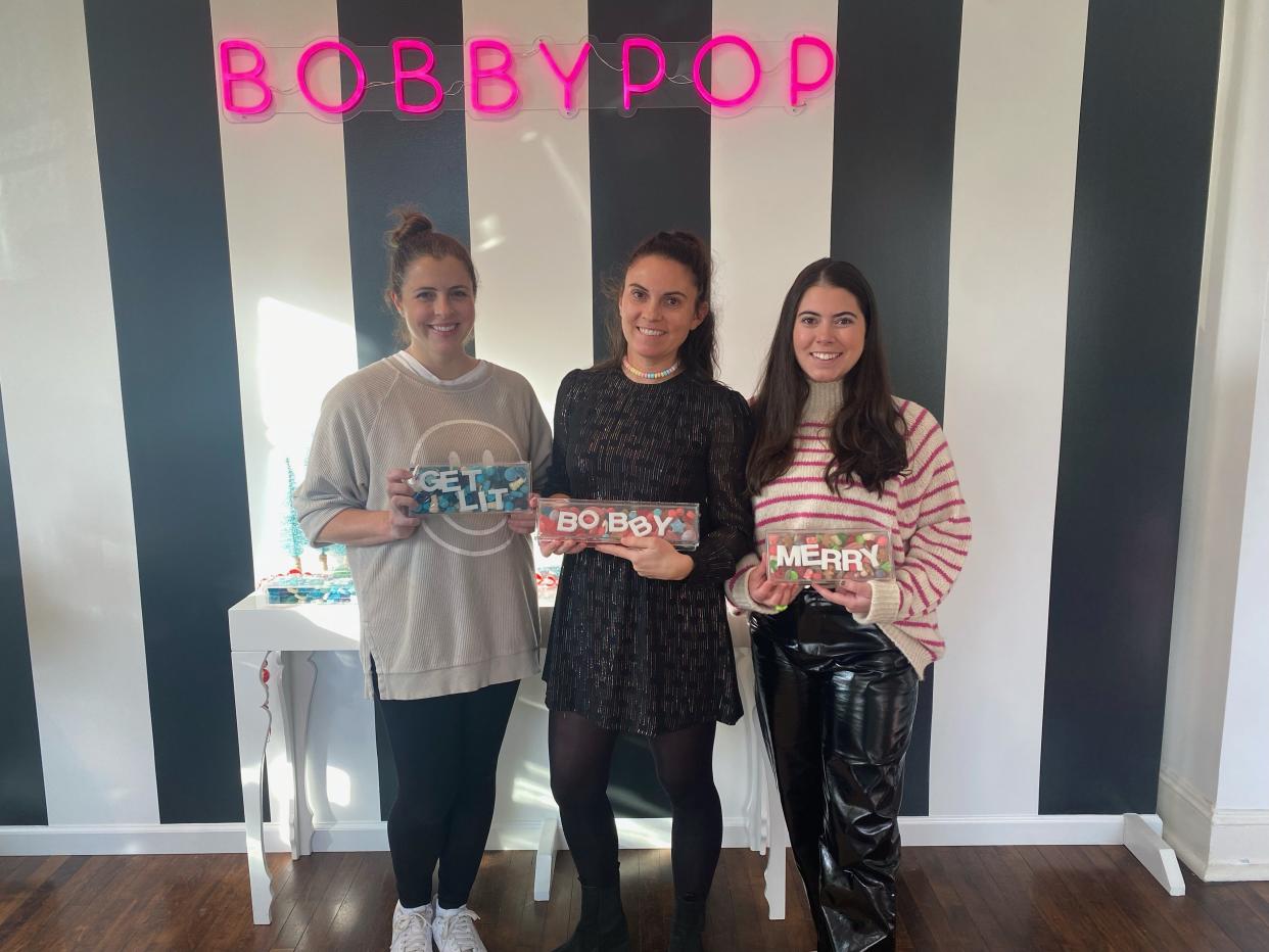 Five sisters who grew up in Bedford, opened BobbyPop candy store in Rye Dec. 2, 2023. These are three of them, from left: Clare Terhune, Erin Murphy and Mary Bachman.