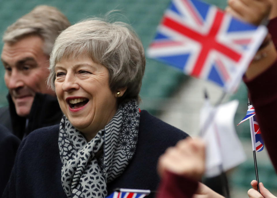 Britain's Prime Minister Theresa May reacts ashildren play rugby, during a visit with Japanese Prime Minister Shinzo Abe to Twickenham Rugby Stadium, in London, Thursday, Jan. 10, 2019. (AP Photo/Frank Augstein, Pool)