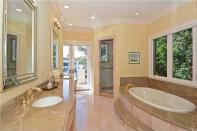 <p>This bathroom also has a relaxing tub and a shower. (Realtor.com) </p>