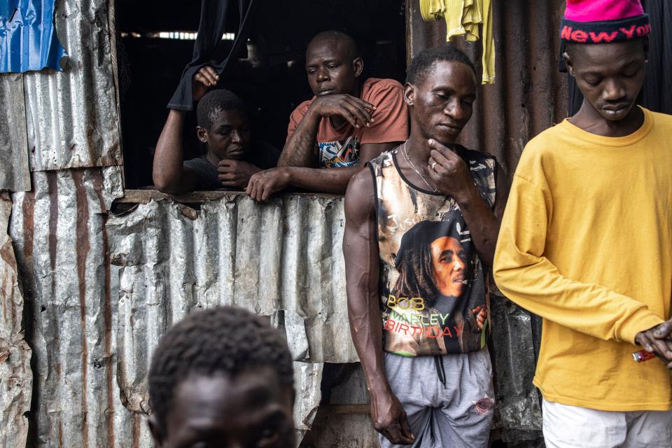 People gather in a Kush drug den in Freetown on June 26, 2023.