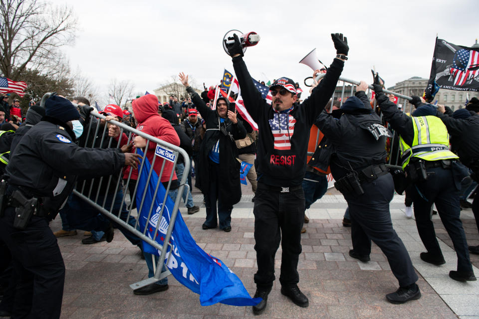 Demonstrators breach security fencing during a protest outside the U.S. Capitol in Washington, D.C., U.S., on Wednesday, Jan. 6, 2021. The House and Senate will meet in a joint session today to count the Electoral College votes to confirm President-elect Joe Biden's victory, but not before a sizable group of Republican lawmakers object to the counting of several states' electors.  (Photo: Graeme Sloan/Bloomberg via Getty Images)