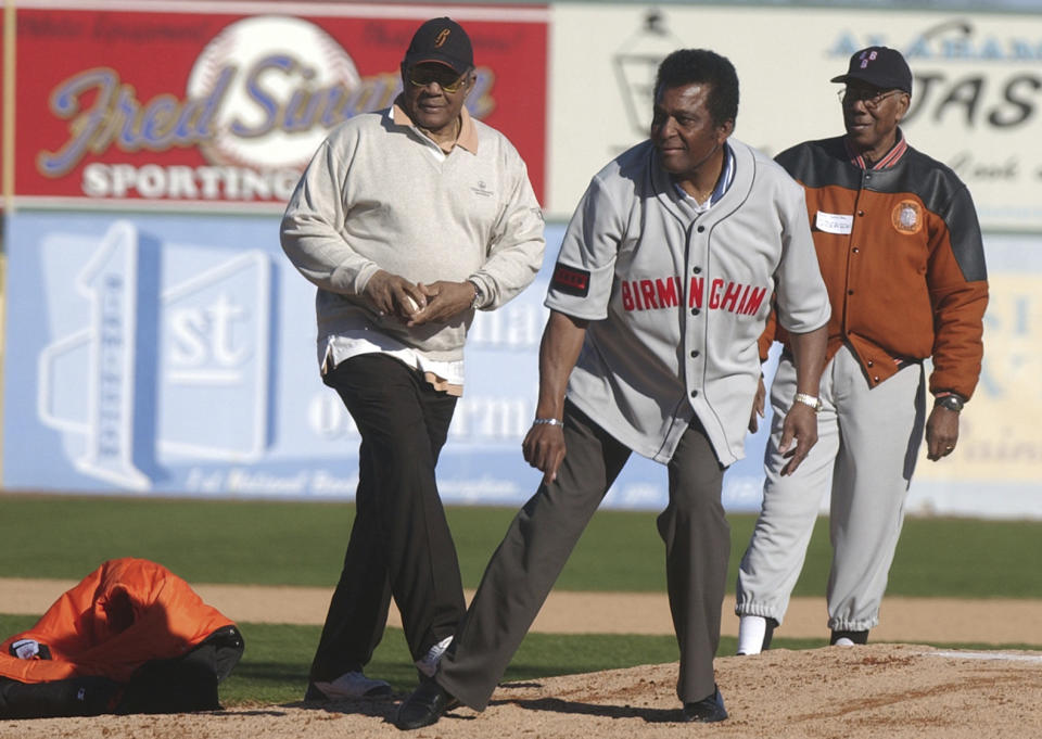 FILE - Former Negro League baseball players, from left, Willie Mays, Charley Pride and Bill Greason throw out first pitches for ESPN Classic's vintage baseball game between the Bristol Barnstormers and the Birmingham Black Barons at Rickwood Field in Birmingham, Ala. Sunday, Feb. 22, 2006. Major League Baseball will stage a Negro Leagues tribute game at Rickwood Field in Birmingham, Alabama, on June 20, 2024, between the San Francisco Giants and the St. Louis Cardinals. The game will honor Hall of Famer Willie Mays, a Birmingham native who began his professional career with the team in 1948. (Linda Stelter/The Birmingham News via AP, File)