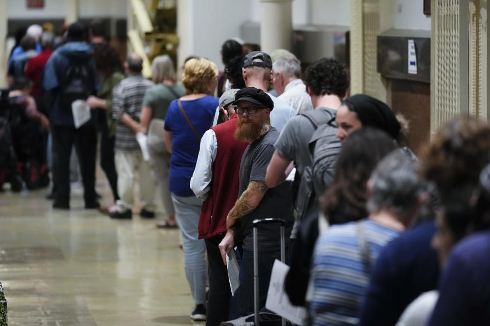 Voters wait in line to make a correction to their ballots for the midterm elections at City Hall in Philadelphia, Monday, Nov. 7, 2022. (AP Photo/Matt Rourke)