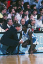 Michael Jordan receives some instructions from his college coach Dean Smith before checking into a game. (Getty Images)