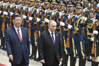 Chinese President Xi Jinping, left, and Russian President Vladimir Putin review the honor guard during an official welcome ceremony in Beijing, China, Thursday, May 16, 2024. (Sergei Bobylev, Sputnik, Kremlin Pool Photo via AP)