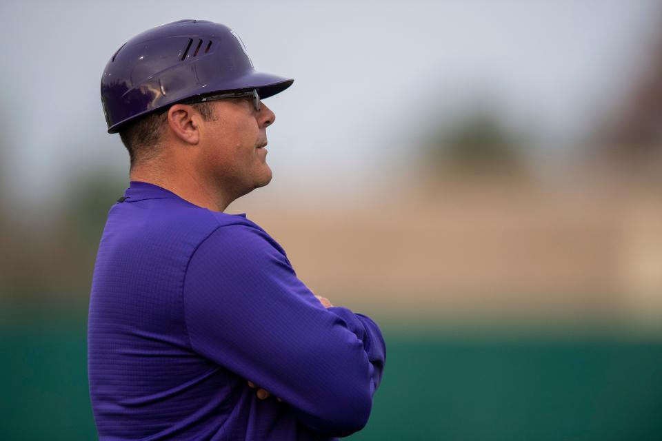 Evansville Head Coach Wes Carroll watches from third base as the University of Evansville Purple Aces play the Valparaiso University Beacons at Charles H. Braun Stadium in Evansville, Ind., Friday evening, April 7, 2023.