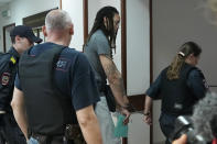 WNBA star and two-time Olympic gold medalist Brittney Griner leaves a courtroom after a hearing, in Khimki just outside Moscow, Russia, Monday, June 27, 2022. More than four months after she was arrested at a Moscow airport for cannabis possession, American basketball star Brittney Griner is to appear in court Monday for a preliminary hearing ahead of her trial. (AP Photo/Alexander Zemlianichenko)