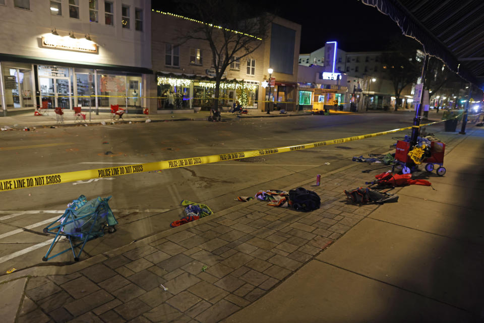 Police tape cordons off a street in Waukesha, Wis., after a vehicle plowed into a Christmas parade hitting more than 20 people Sunday, Nov. 21, 2021. (AP Photo/Jeffrey Phelps)