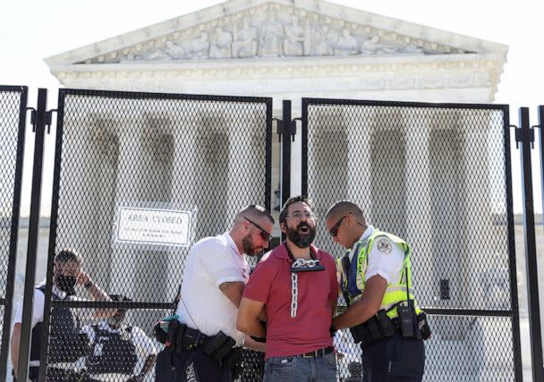 PHOTO: Police arrest abortion rights activist Guido Reichstadter of Miami after he chained himself to security fencing while protesting against the court's expected decision overturning the Roe v Wade ruling outside the Supreme Court, June 6, 2022. (Evelyn Hockstein/Reuters)