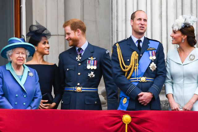 <p>Anwar Hussein/WireImage</p> Queen Elizabeth, Meghan Markle, Prince Harry, Prince William and Kate Middleton on the balcony of Buckingham Palace for the RAF centenary flypast in July 2018.