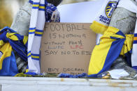 Close up of a banner as fans protest outside Elland Road against Liverpool's decision to be included amongst the clubs attempting to form a new European Super League, in Leeds, England, Monday, April 19, 2021. Reaction to the proposals from 12 clubs to rip up European soccer by forming a breakaway Super League has ranged from anger and condemnation to humor and sarcasm. (Zac Goodwin/PA via AP)